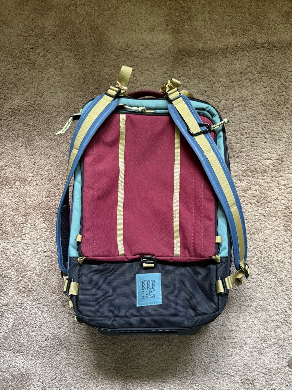 Topo Designs Backpack in Burgundy, Blue, Black with Yellow Accents